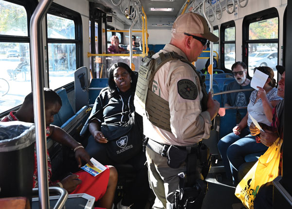 Deputy Maselli, LASD Transit Services Bureau, discuss fare evasion with AVTA riders.